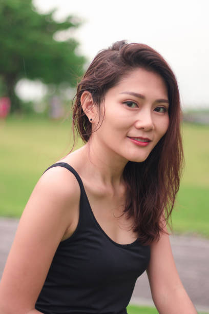 istock woman sat in the park and smiled 1159086443