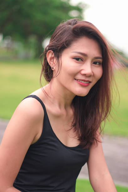 istock woman sat in the park and smiled 1159086471