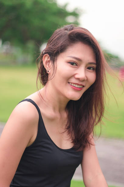 istock woman sat in the park and smiled 1159086519