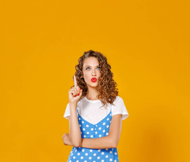 istock beautiful funny girl on colored yellow background 1159087185