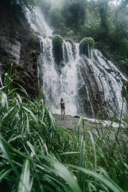 istock Woman walking near Tumpak Sewu waterfall on Java 1159090143