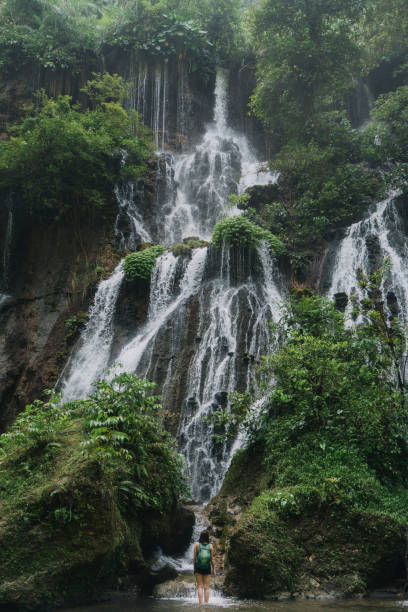 istock Woman walking near Tumpak Sewu waterfall on Java 1159090146