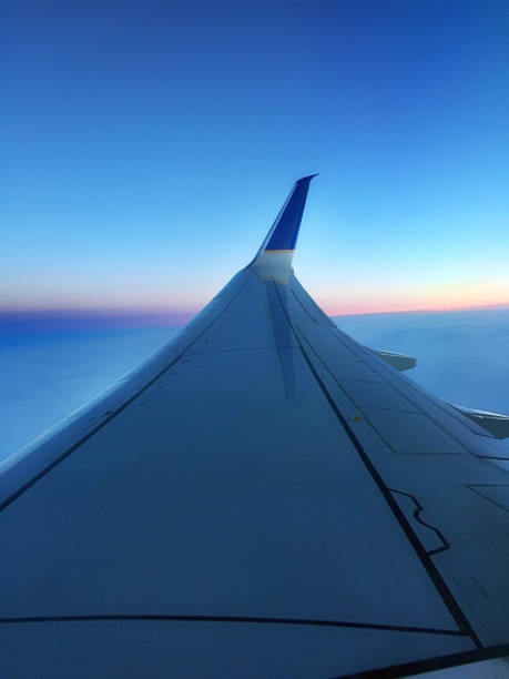 istock wing of an airplane at sunset 1159090913