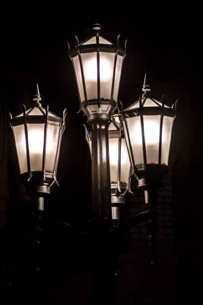 istock black iron street lamp at night 1159093664