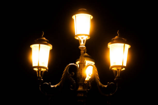 istock black iron street lamp at night 1159094709