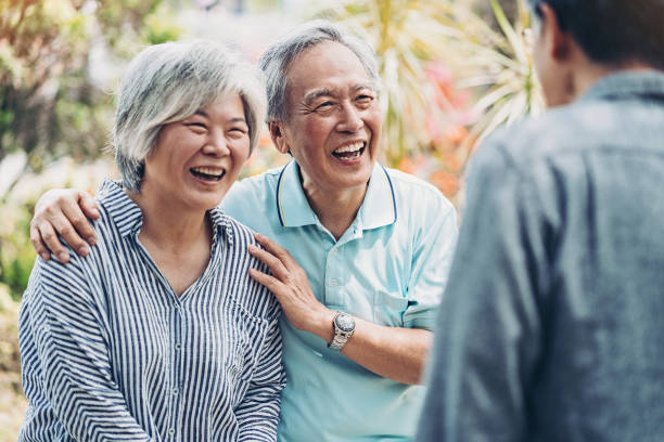 istock Senior couple enjoying a conversation with a friend 1159095641