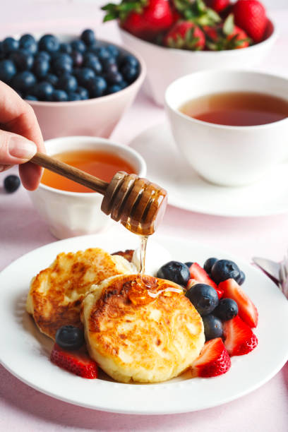 istock Cottage cheese pancakes with honey and berries for breakfast or lunch 1159097436