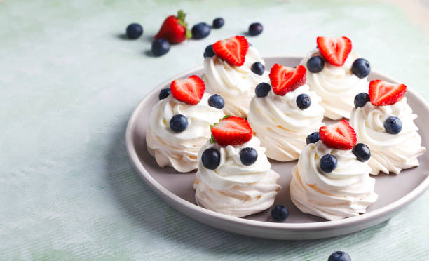 istock Mini Pavlova meringue with whipped cream and berries. 1159098366