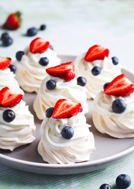 istock Mini Pavlova meringue with whipped cream and berries. 1159098870
