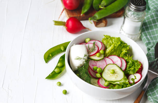 istock Spring vegetable salad with radish, cucumber and green peas 1159099095
