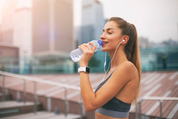 istock Woman runner is having a break and drinking water Hong Kong 1159100420