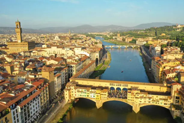 Photo of Aerial view of the Arno river and Ponte Vecchio bridge at sunset
