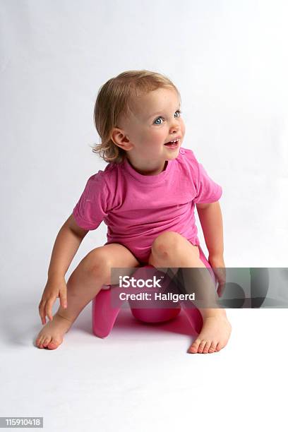 A Picture Of A Little Girl Wearing Pink On A Pink Potty Stock Photo - Download Image Now