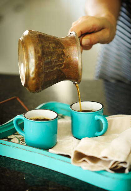 istock A woman is pouring coffee in a cups 1159106109