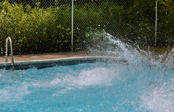 istock Beautiful splashing water in swimming pool 1159110814