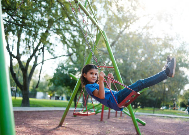 istock Latin girl on a swing 1159111684