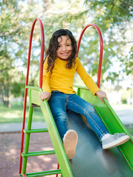 istock Happy little girl sliding 1159111698