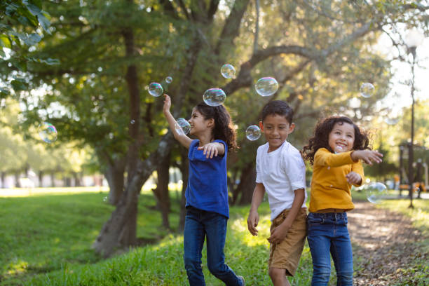 Children playing with bubbles outdoors