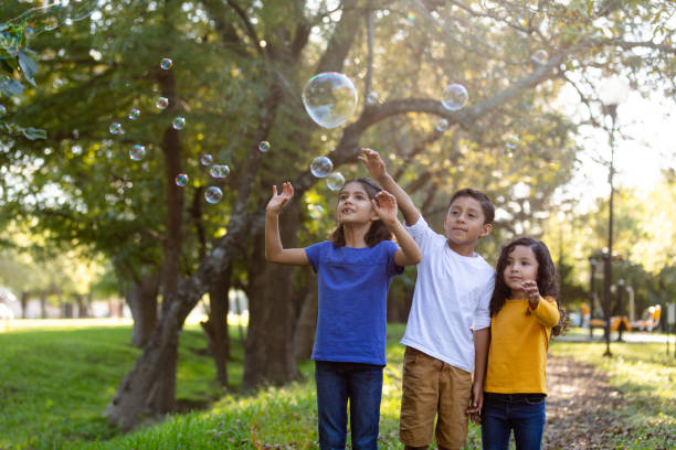 istock Little kids playing with bubbles 1159111719
