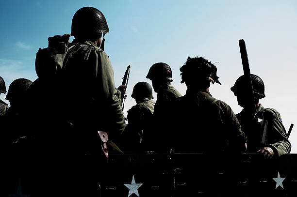 Advancing the battle, two World War II combat Soldiers take off charging across an open field.