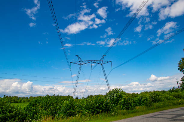 istock High-voltage power transmission line against a cloudy sky. 1159112746