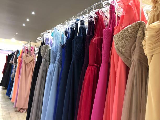 Rows of bright dresses Unrecognisable dresses in many bright hues, all in a row evening gown stock pictures, royalty-free photos & images