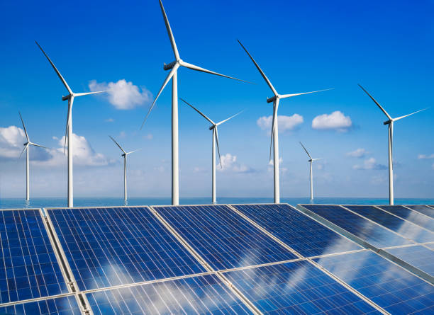 istock Solar panel and wind turbine farm clean energy. 1159119760
