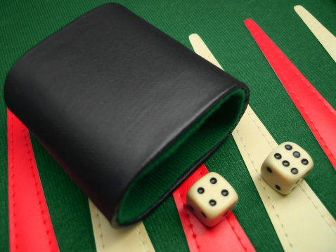 A close-up of a backgammon game, with 2 dices thrown