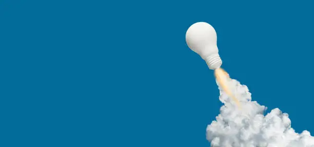 Photo of Ideas inspiration concepts with rocket lightbulb on blue background.Business start up or goal to success