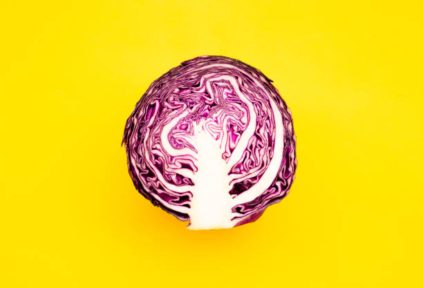 istock Fresh of purple cabbage (half sliced)on color background 1159122827