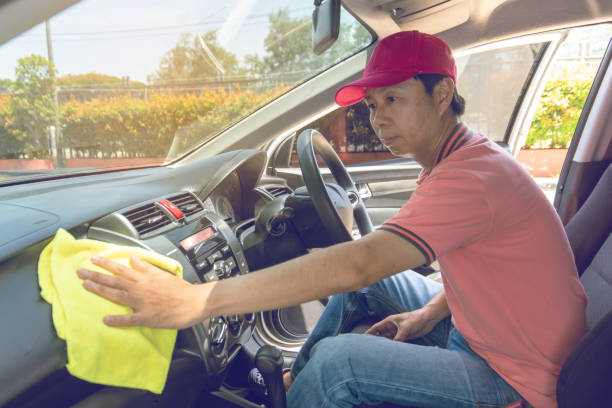 istock Auto service staff cleaning car with microfiber cloth 1159123651