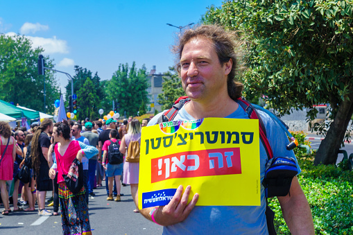 Haifa, Israel - June 28, 2019: People with protest signs in the annual pride parade of the LGBT community, in the streets of Haifa, Israel