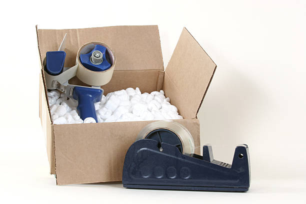 istock Packing materials tape, cardboard box peanuts dispenser 115912887