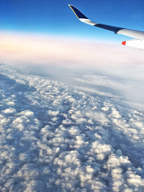 istock sunset sunrise above heavy cloud aerial view with plane wing 1159131307