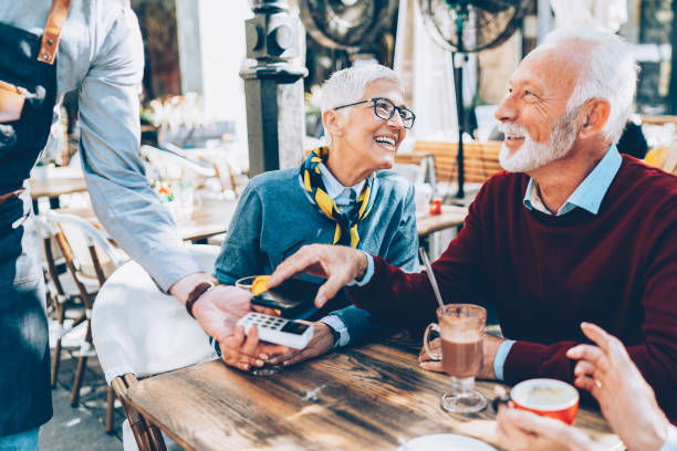 istock Senior Couple paying contactless 1159134344