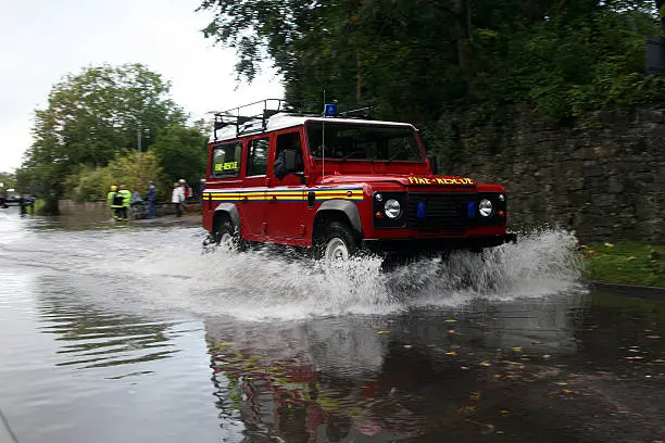 fire department 4x4 driving on flooded road