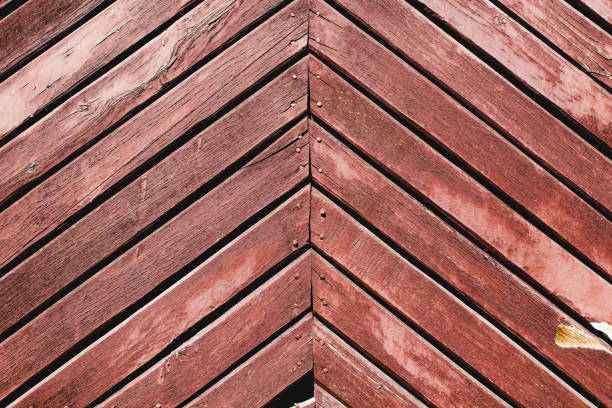 Red, old wooden doors with peeling paint, abstract background of planks