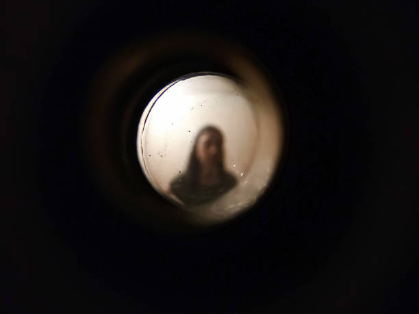 Woman seen through the peephole
