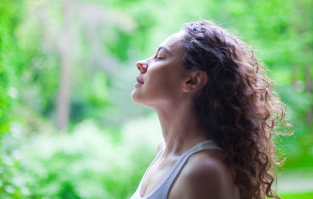 istock Woman breathing fresh air outdoors in summer 1159140262
