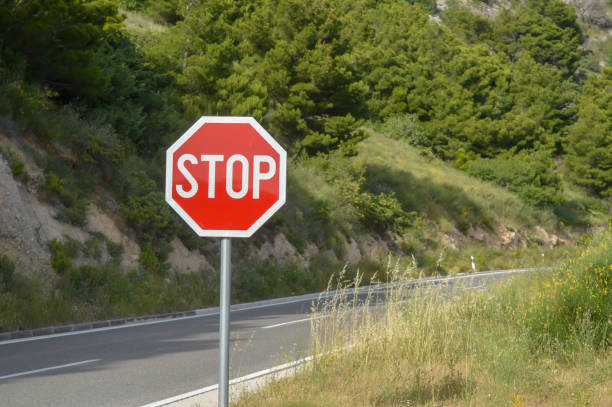 istock Stop sign on Adriatic Sea coast road 1159141275