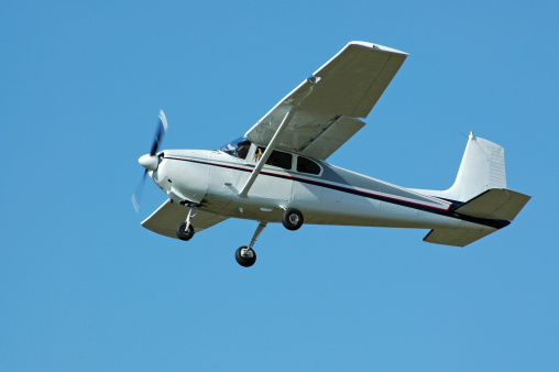 private airplane Cessna 182 flying in clear blue sky