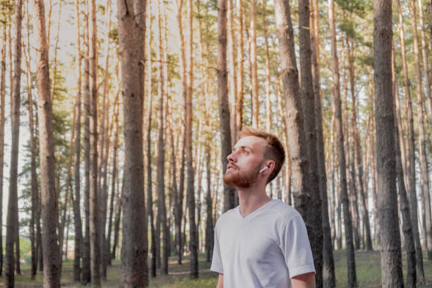 istock Young man enjoying the nature during a walk or jogging in the forest. 1159148481