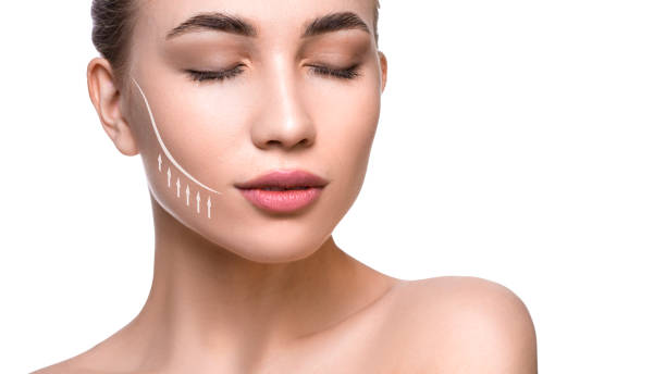 Close up portrait of a beautiful woman with lifting lines on the face. Face lifting and skin care concept Close up portrait of a beautiful woman with lifting lines on the face. Face lifting and skin care concept. cheek photos stock pictures, royalty-free photos & images