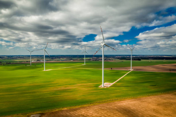 istock White wind turbines and green field, Poland from above 1159149654