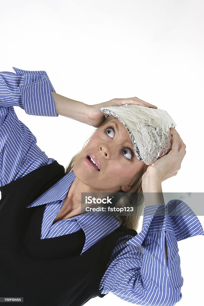 Woman fearing invasion from aliens, radio waves or cell signals. Woman fearing invasion from aliens, radio waves or cell phone signals.  She wears a tin foil hat. Adult Stock Photo