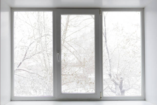 istock Modern residential window with snow and trees 1159155765