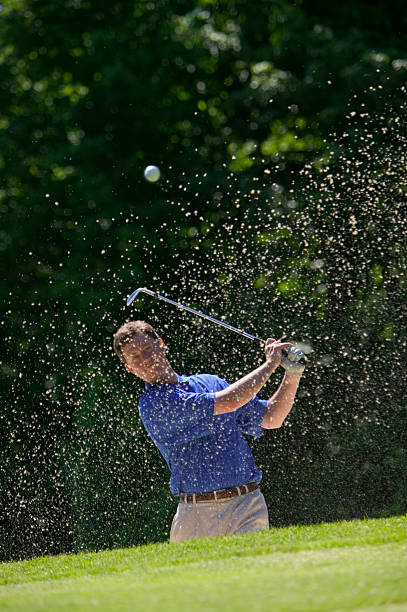 istock Golfer Chipping from Sand Trap 115915712