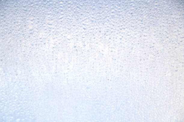 istock water dew drop on mirror of car, blur style for background 1159160332