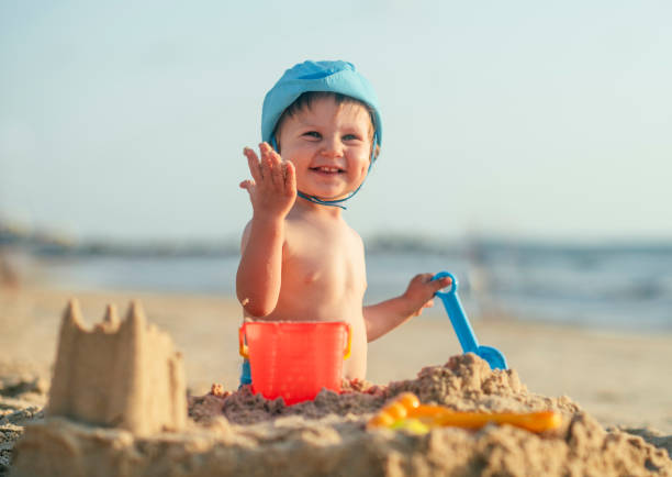 Child playing with sand in sunset
