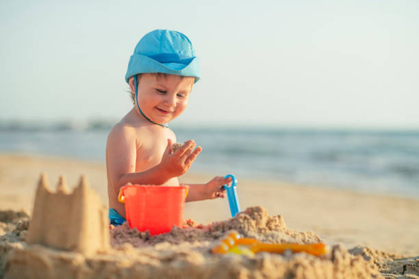 Child playing with sand in sunset